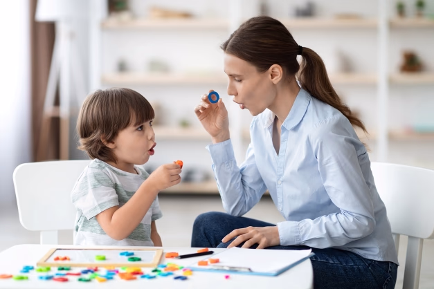 Image of Person Doing Speech Therapy with an autistic child.